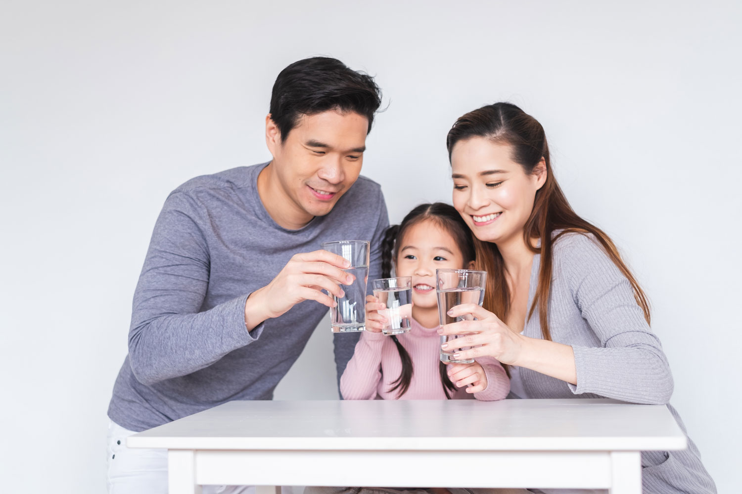 Happy Asian Family Drinking Fresh Water